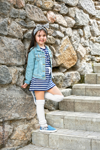 Little girl wearing stylish...