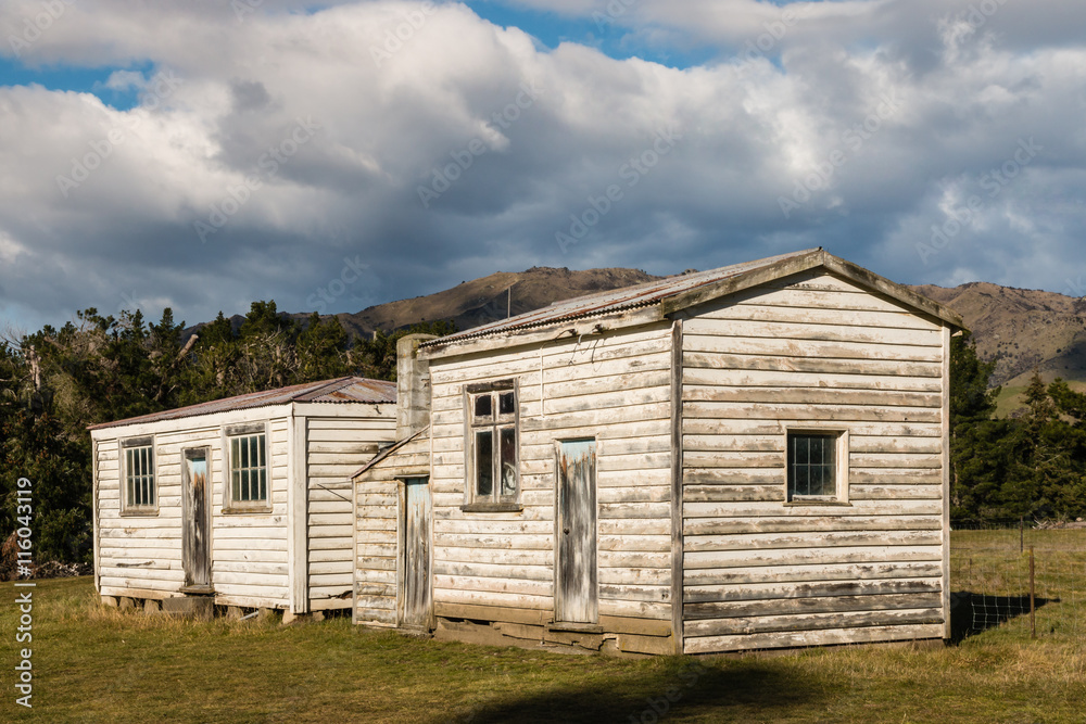 abandoned whitewashed farm house