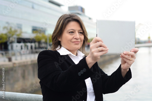 Business woman taking selfie with her tablet.