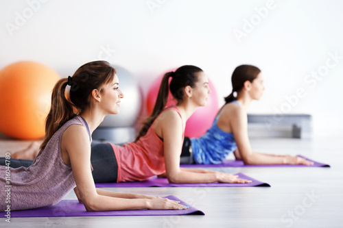 Young women doing yoga in gym