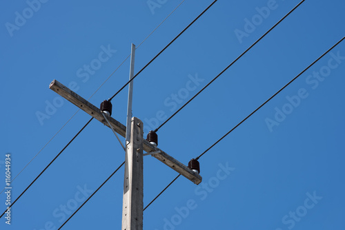 Tableau sur toile High voltage wires on the background of blue sky and clouds