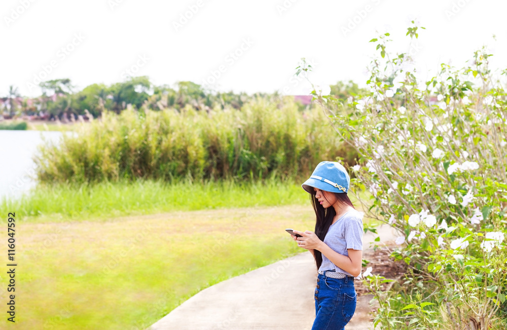 woman in garden using a mobile telephone