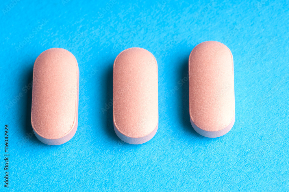 Many pills and tablets isolated on light blue background Many pills and tablets isolated on light blue background