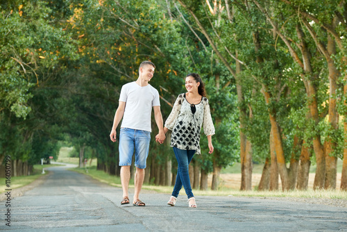 Fototapeta Naklejka Na Ścianę i Meble -  happy young couple walk on country road outdoor, romantic people concept, summer season