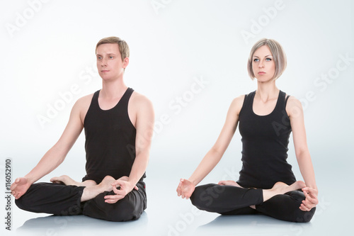 Man and woman meditating in lotus position