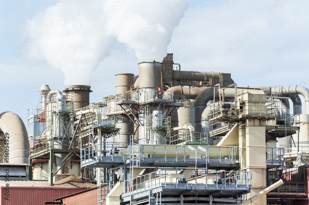 industrial plant of a furniture factory with smoking smokestacks industrial plant of a furniture factory with smoking smokestacks