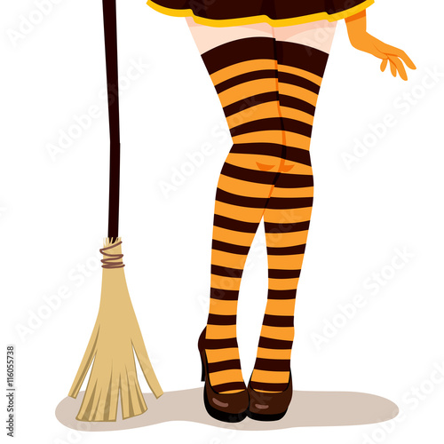 Closeup of woman legs in sexy Halloween witch costume with mini skirt, orange and black stripes stockings, heel shoes and broom