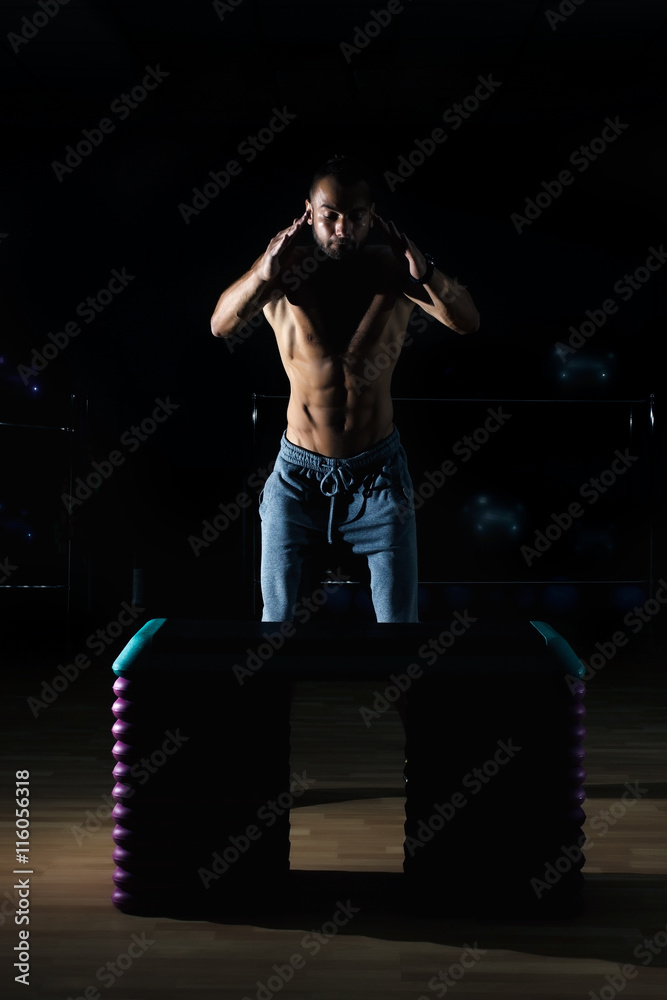 Athlete gave exercise. Jumping on the box. Phase touchdown. Athlete gave exercise. Jumping on the box. Phase touchdown.