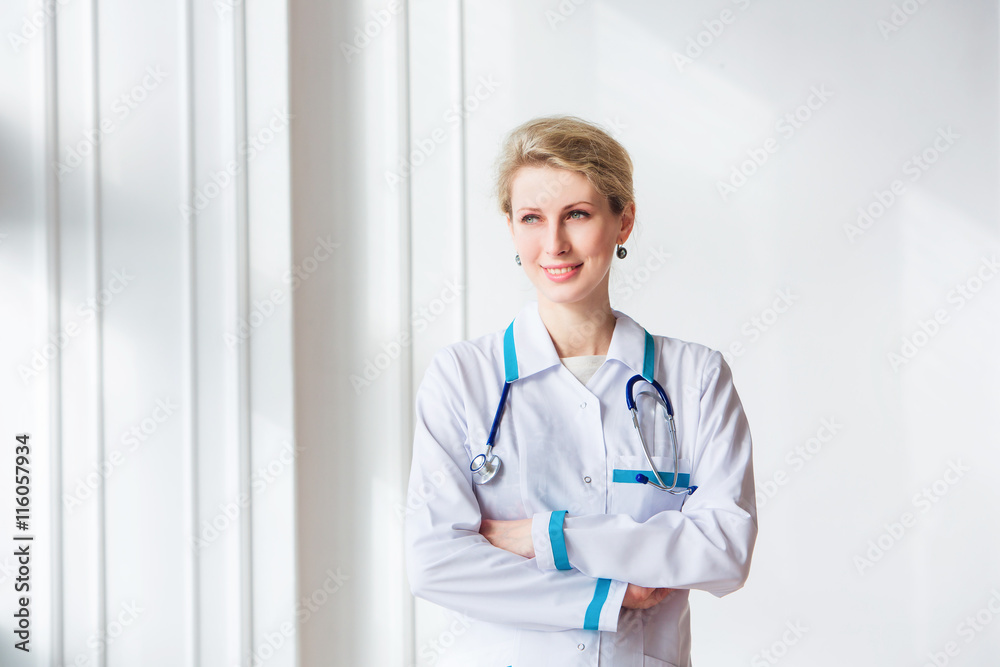 Doctor with stethoscope around his neck looking at the camera smiling Doctor with stethoscope around his neck looking at the camera smiling