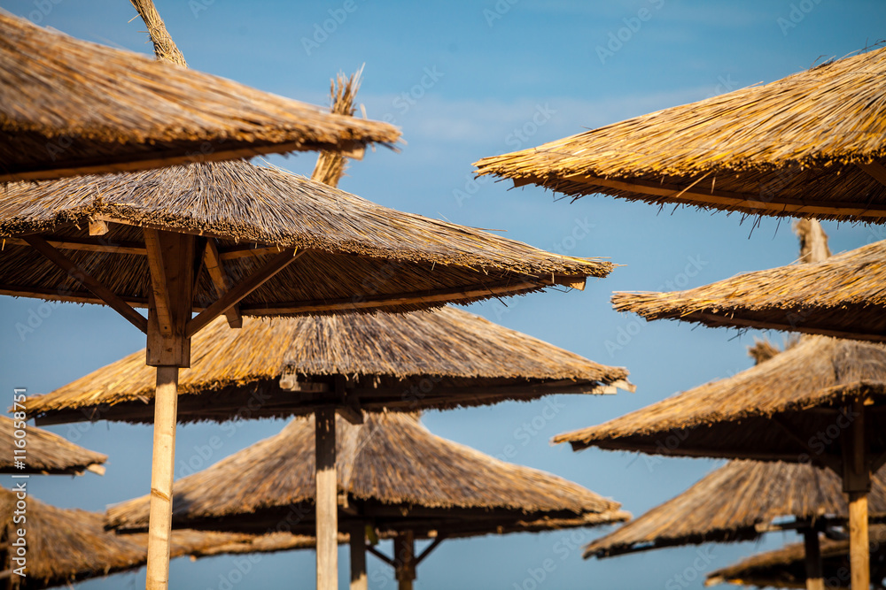 Fototapeta premium Color picture of straw beach umbrella