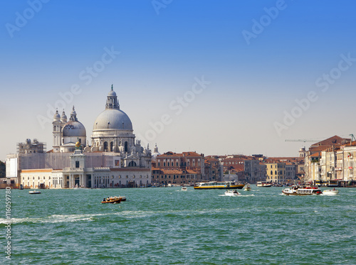 Grand Canal with boats and Basilica Santa Maria della Salute, Venice, Italy..