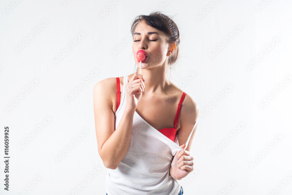 Young brunette model with lollipop posing studio shot on white background, not isolated Young brunette model with lollipop posing studio shot on white background, not isolated