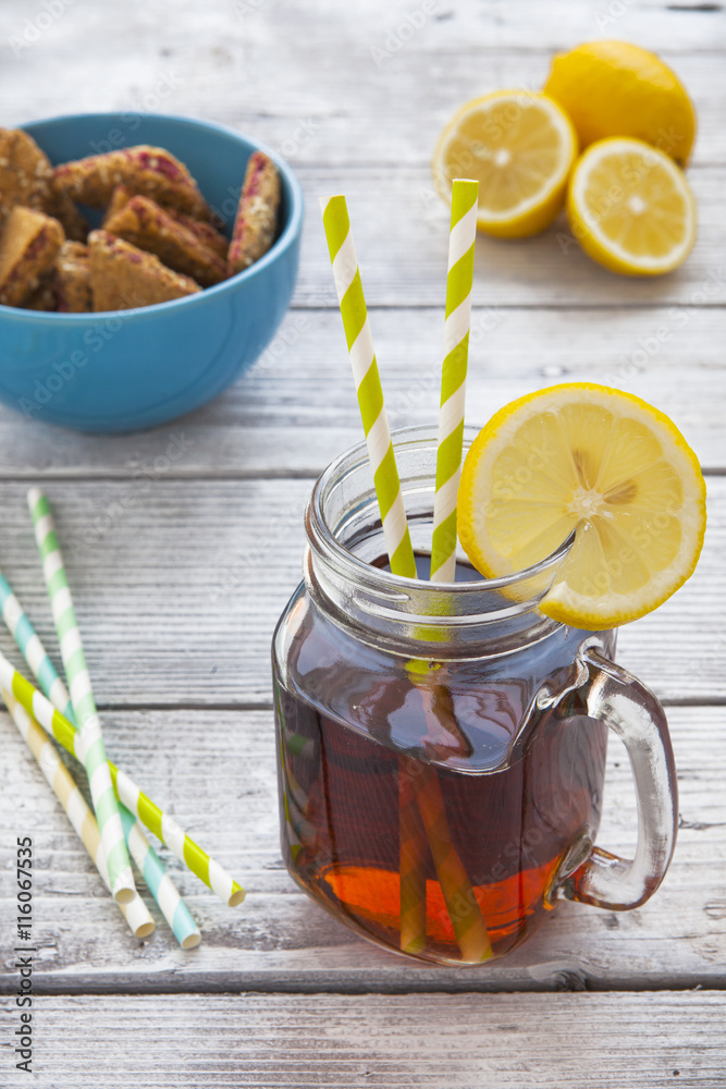 Iced tea with lemon slices and raspberry chip cookies on rustic Iced tea with lemon slices and raspberry chip cookies on rustic