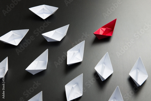 Leadership concept illustrated with paper ships