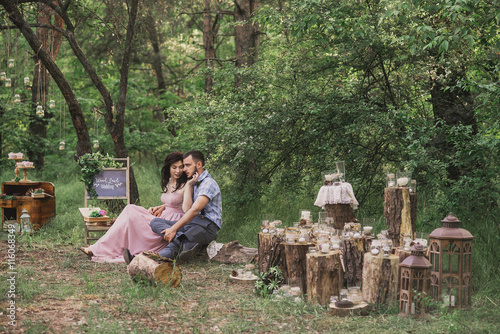 Man and woman in retro styled wear pose in the vintage decorations outdoor