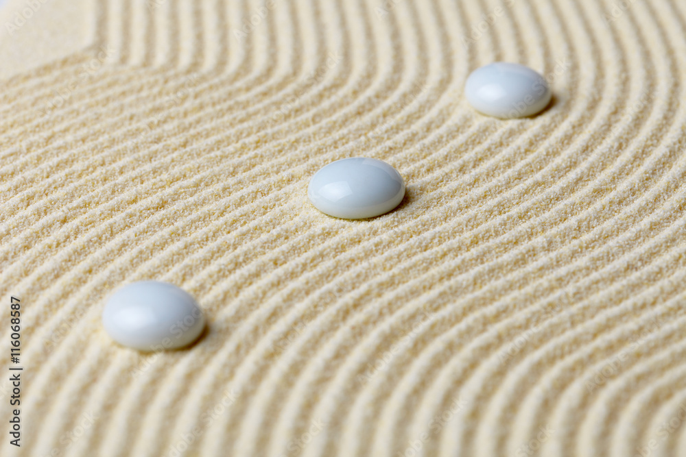 Art composition from white stones on yellow sand Art composition from white stones on yellow sand