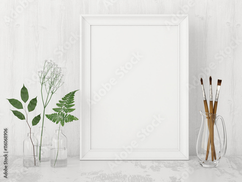 Vertical interior poster mock up with empty frame, artistic brushes and plants in bottles on white wall background. 3D rendering.