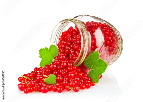 Fresh red currant with green leaf in glass jar