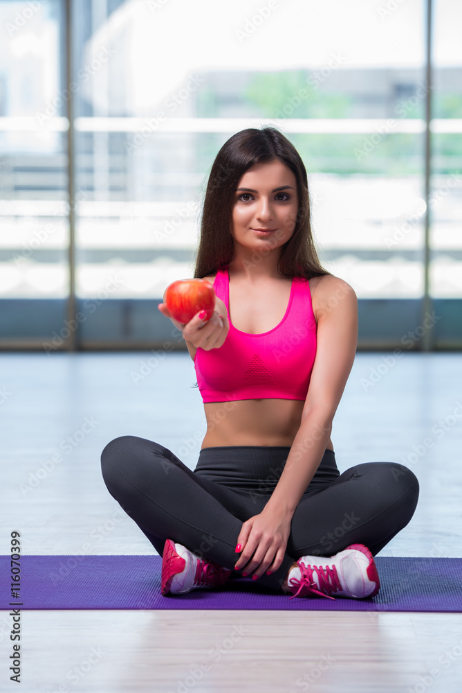 Young woman eating red apple in health concept Young woman eating red apple in health concept
