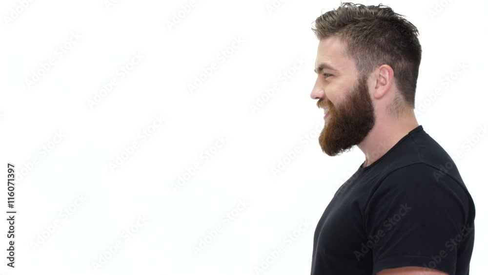 Young handsome bearded man smiling and talking with somebody Young handsome bearded man smiling and talking with somebody