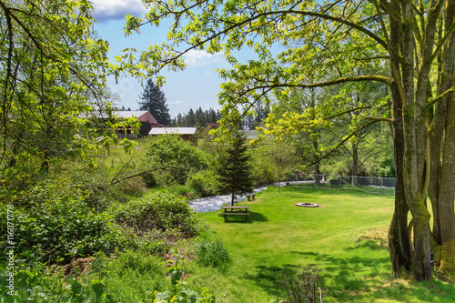 Mountain river view in grassy back yard of American rambler