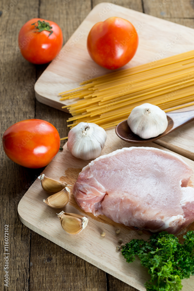 Food series : Raw pork on wooden cutting board and spaghetti Food series : Raw pork on wooden cutting board and spaghetti
