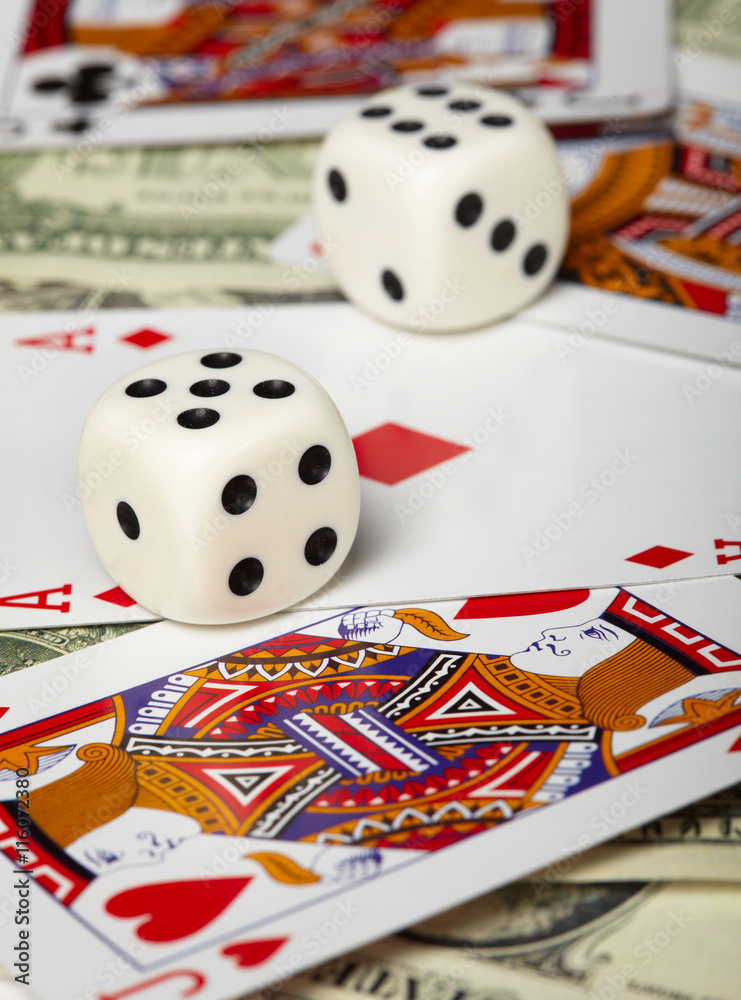 Dice against of playing cards and money Dice against of playing cards and money