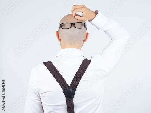 back of a bald-headed man with glasses on nape