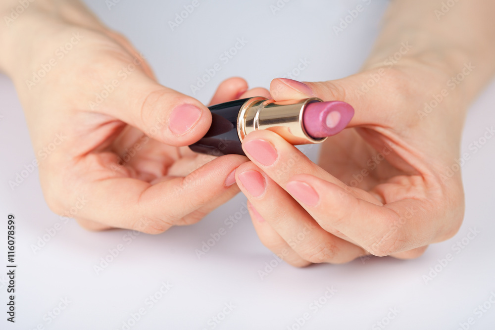 Red lipstick in hands Red lipstick in hands
