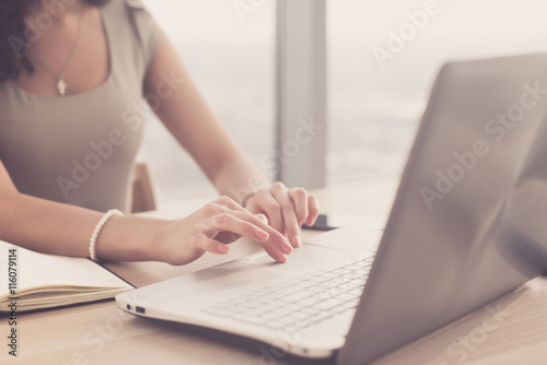 Close-up portrait of an office worker browsing, searching and analyzing new business ideas, surfing the internet at her workplace.