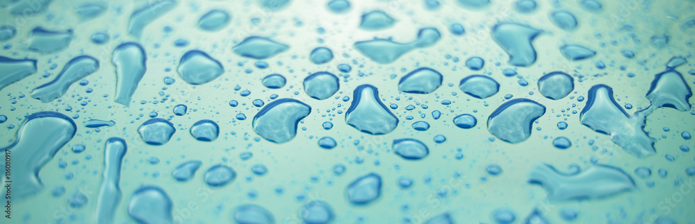 Water drops on surface of blue plastic