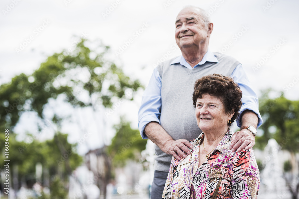 Portrait of senior woman with her husband in the background Portrait of senior woman with her husband in the background