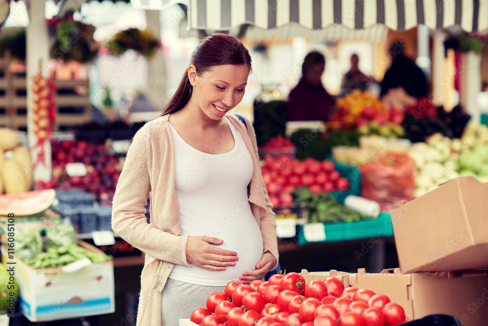 pregnant woman choosing food at street market pregnant woman choosing food at street market