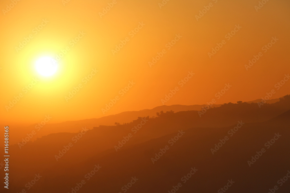 Amazing sunset over a hill landscape