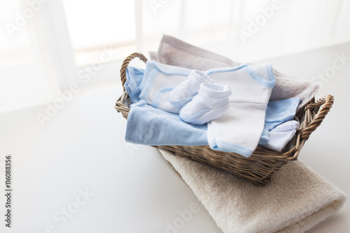 close up of baby clothes for newborn boy in basket photo