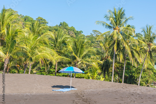 Beach umbrella and towel at playa hermosa en Costa Rica - pacific coast