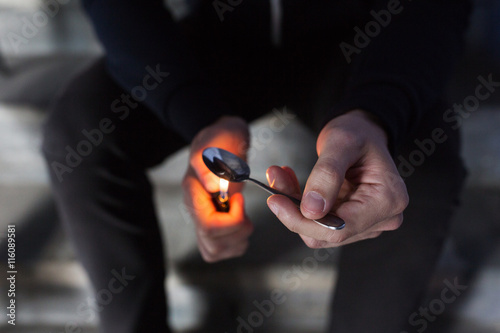 close up of addict preparing crack cocaine drug photo