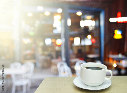 Blurred background : white cup of coffee and customer at restaur