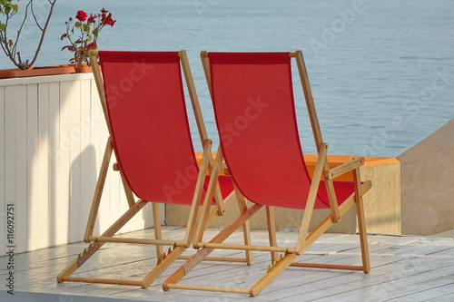 Two Wooden Folding Armchair On The Sea View Beach Patio