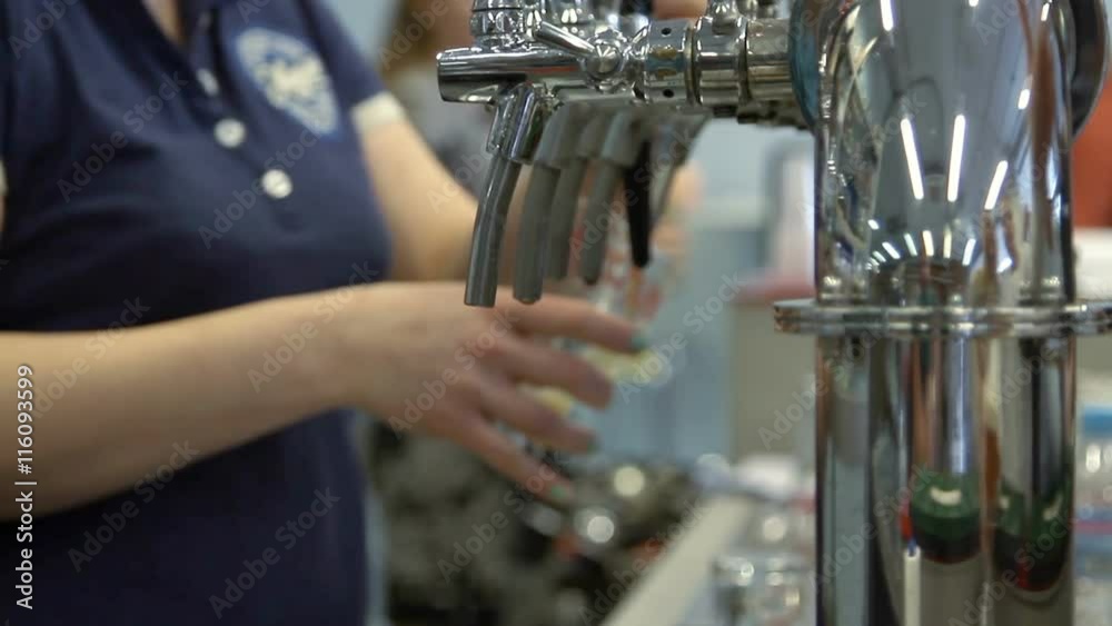 Barman pulling a pint of beer behind the bar Barman pulling a pint of beer behind the bar