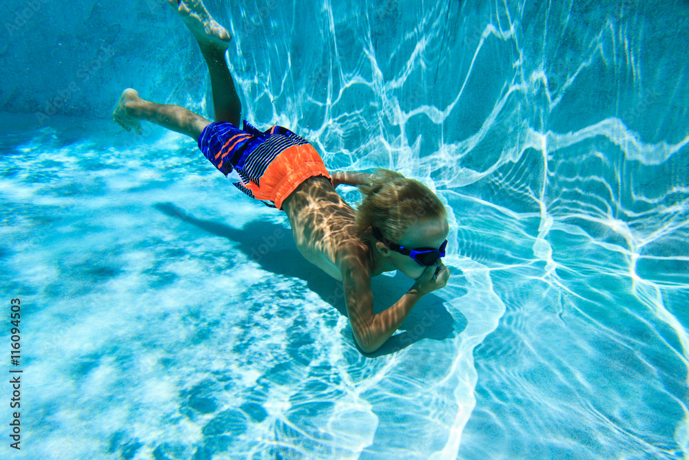 little boy swimming diving underwater