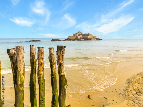 Wooden breakwaters in low tide and Fort National