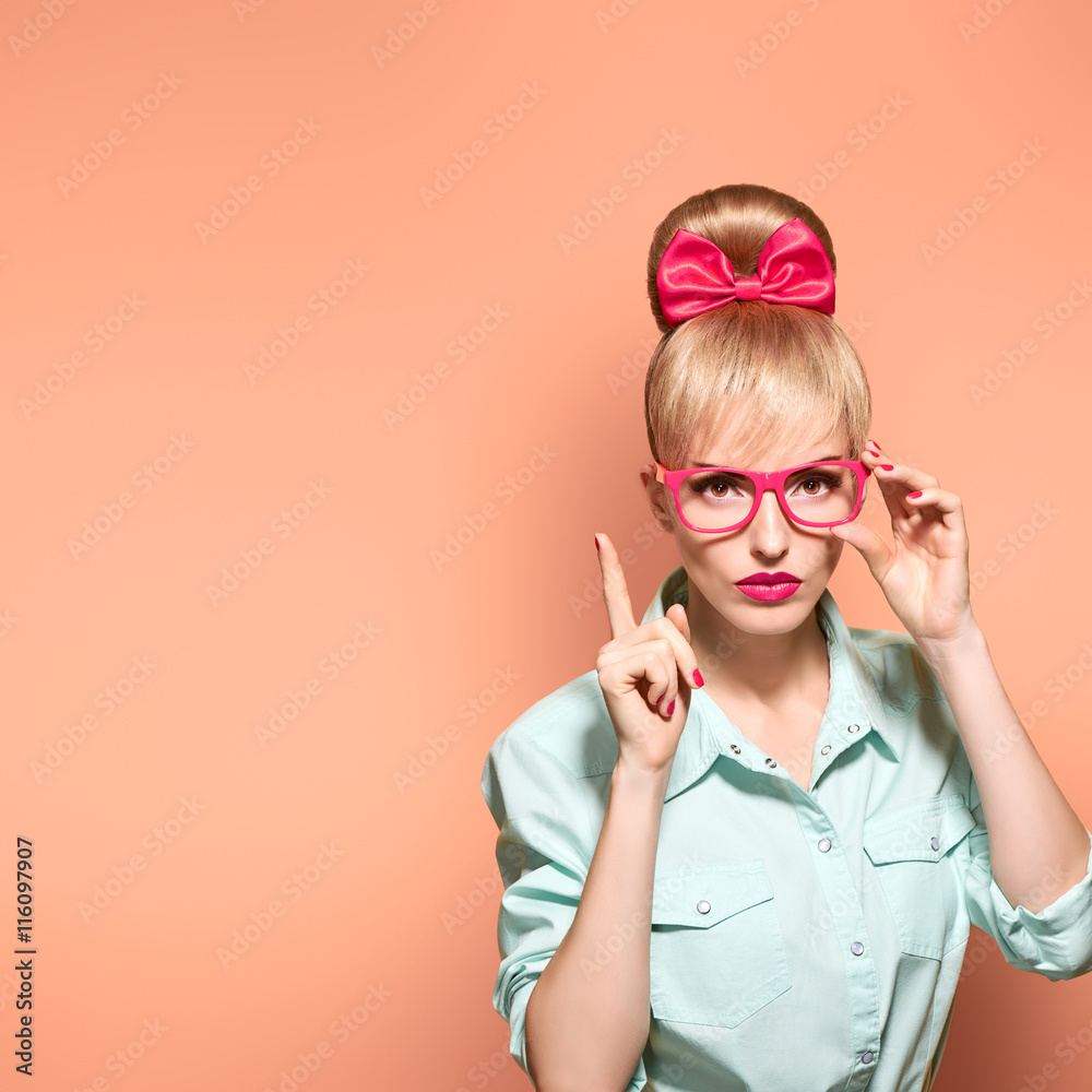 Fashion. Woman in Stylish Glasses Having Fun. Hipster fashion girl think, idea. Playful nerd Blonde with Glamour Pinup Stylish hairstyle, Trendy fashion, red bow Makeup. Unusual Creative, on pink Fashion. Woman in Stylish Glasses Having Fun. Hipster fashion girl think, idea. Playful nerd Blonde with Glamour Pinup Stylish hairstyle, Trendy fashion, red bow Makeup. Unusual Creative, on pink