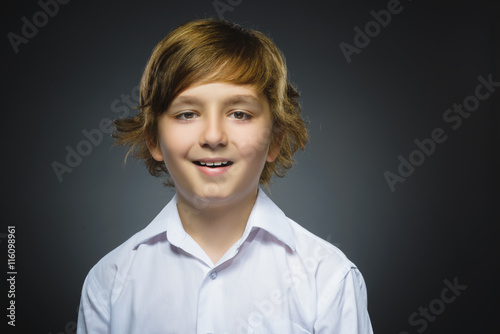 doubt, expression and people concept - boy thinking over gray background