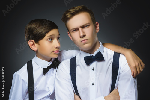 boy looks questioningly at disaffected teenager or brother