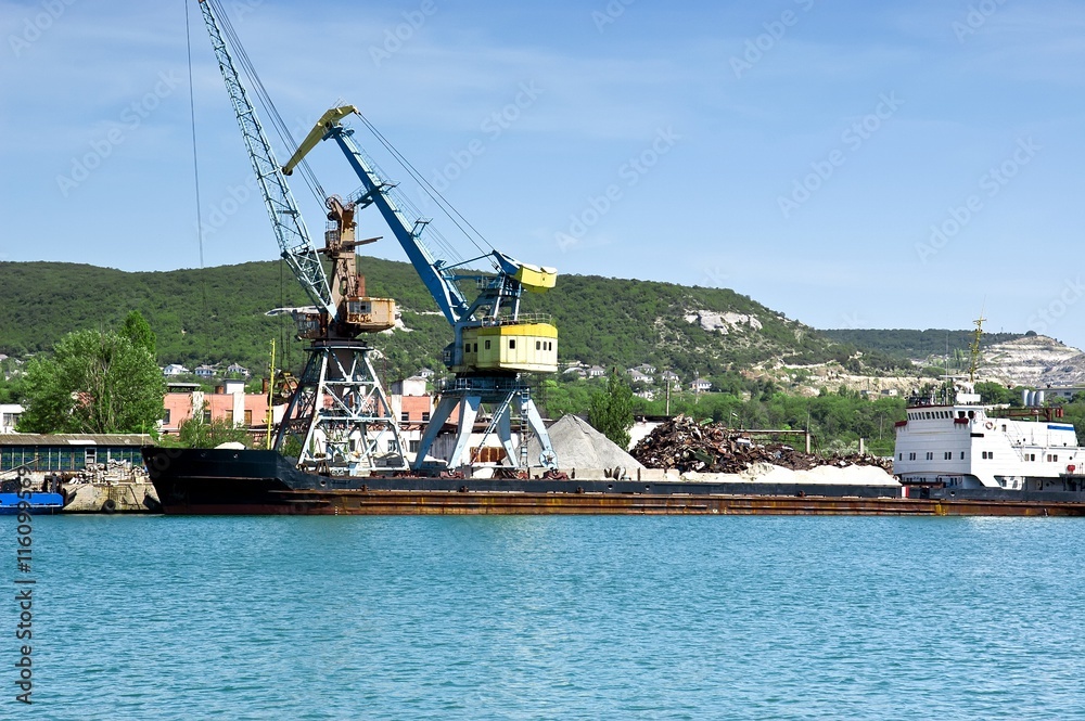 Cargo ship docked for loading in old harbor. Cargo ship docked for loading in old harbor.