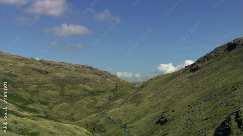 Little Langdale Tarn Revealed From The Top Of Wrynose Pass With Reveal Shot Of Landscape Below. Little Langdale Tarn Revealed From The Top Of Wrynose Pass With Reveal Shot Of Landscape Below.