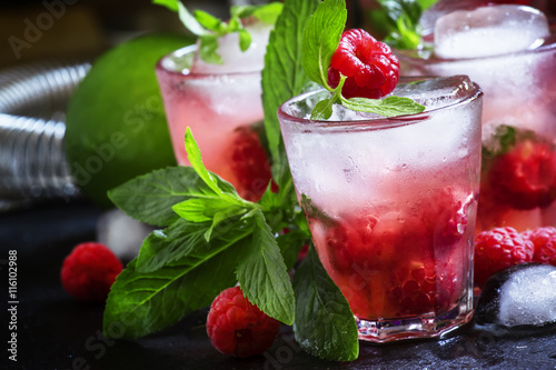 Raspberry mojito alcoholic cocktail with berries, lime, mint and