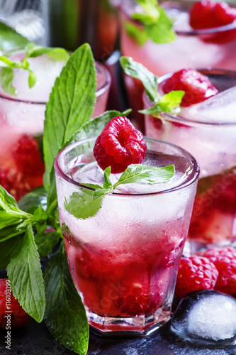 Raspberry mojito alcoholic cocktail with berries, lime, mint and