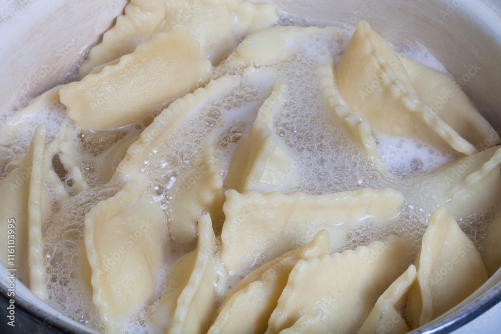 Russian ravioli - pelmeni are boiling in broth . Cooking process Russian ravioli - pelmeni are boiling in broth . Cooking process